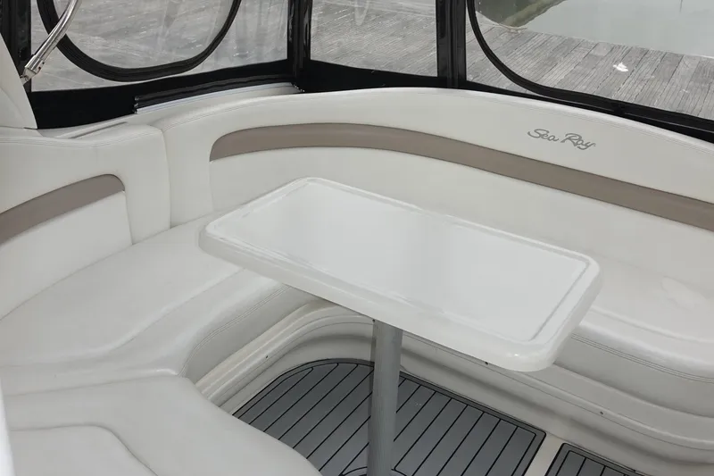 Slide: The Image of Interior seating area of 2005 Sea Ray 320 Sundancer boat with table. - 9