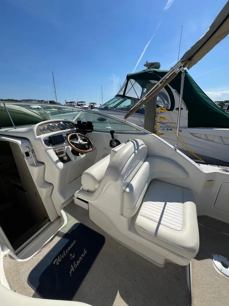 Slide: The Image of Interior of 2001 Sea Ray 270 Sundancer boat with helm and seating. - 11