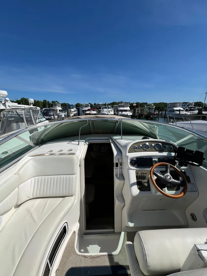 Slide: The Image of Cockpit view of a 2001 Sea Ray 270 Sundancer yacht docked at a marina. - 13