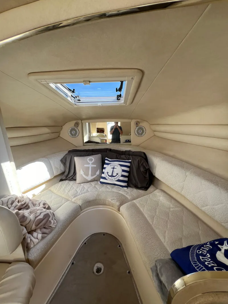 Slide: The Image of Interior cabin of a 2001 Sea Ray 270 Sundancer with nautical-themed pillows. - 18