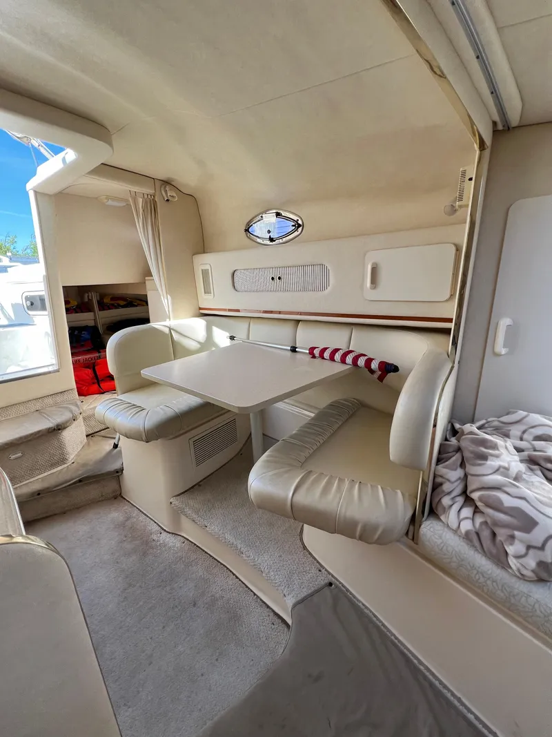 Slide: The Image of Interior of 2001 Sea Ray 270 Sundancer with dining area and seating. - 19