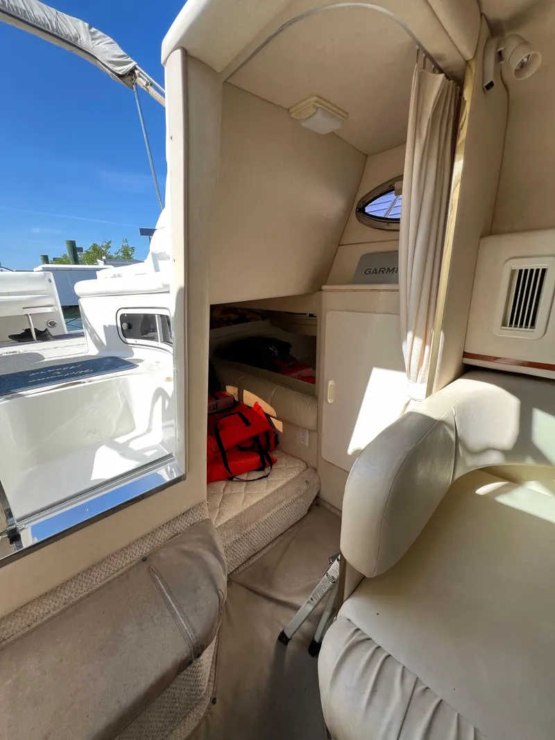 Slide: The Image of Interior cabin of a 2001 Sea Ray 270 Sundancer boat with seating and storage. - 20