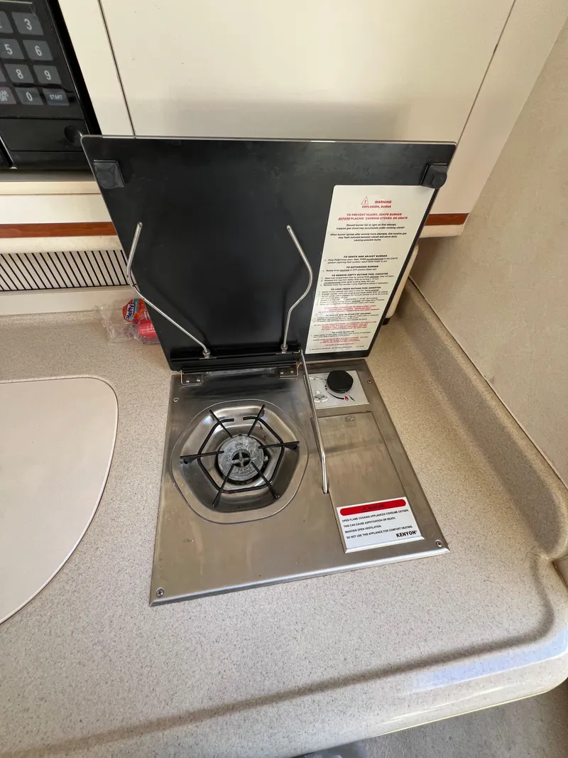 Slide: The Image of Sea Ray 270 Sundancer 2001 boat interior stove with safety instructions. - 35