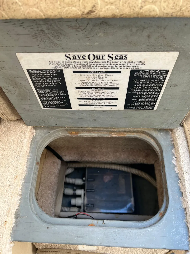 Slide: The Image of Sea Ray 270 Sundancer 2001 boat storage compartment with Save Our Seas environmental notice. - 39