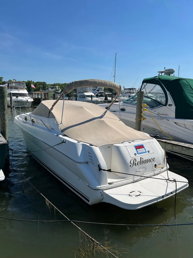 Slide: The Image of 2001 Sea Ray 270 Sundancer boat docked in a marina on a sunny day. - 4