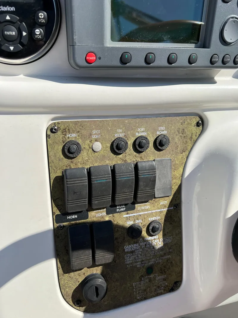 Slide: The Image of Control panel of a 2001 Sea Ray 270 Sundancer boat with various switches and buttons. - 41