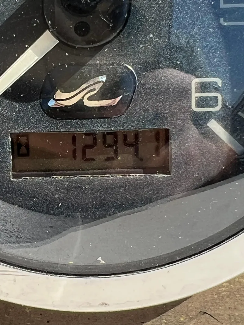 Slide: The Image of Close-up of 2001 Sea Ray 270 Sundancer boat gauge displaying 1294.1 hours. - 45