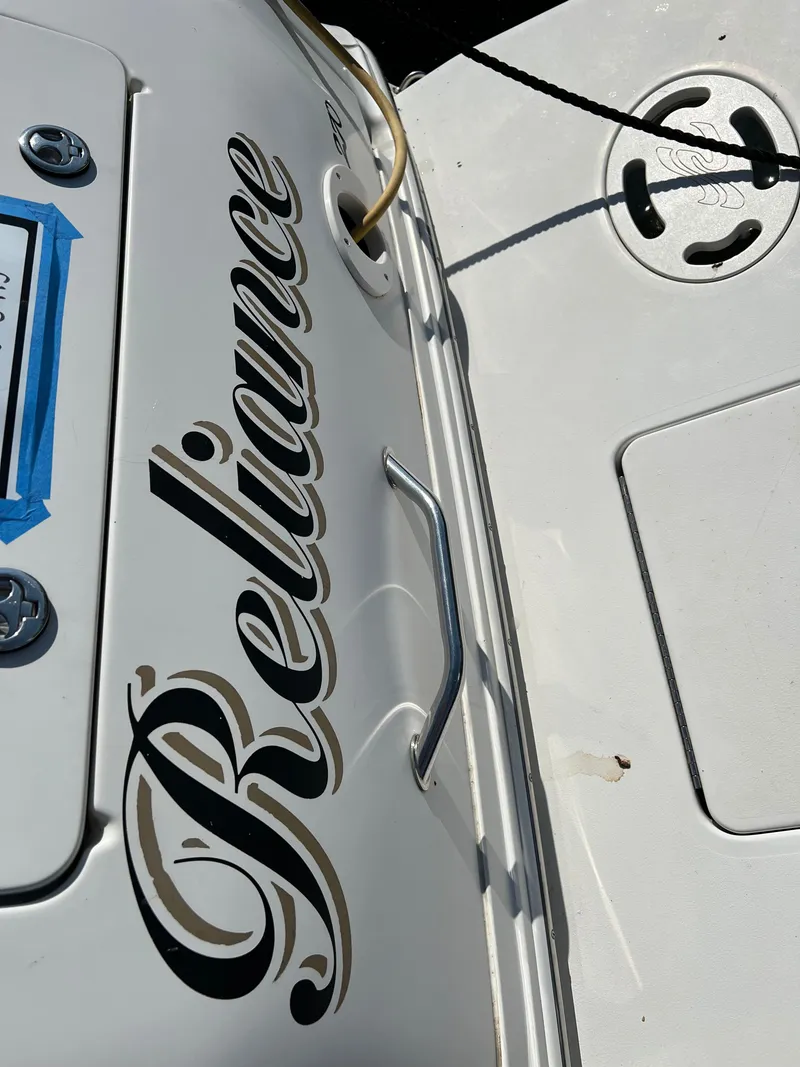 Slide: The Image of Close-up of 2001 Sea Ray 270 Sundancer boat with Reliance name. - 46