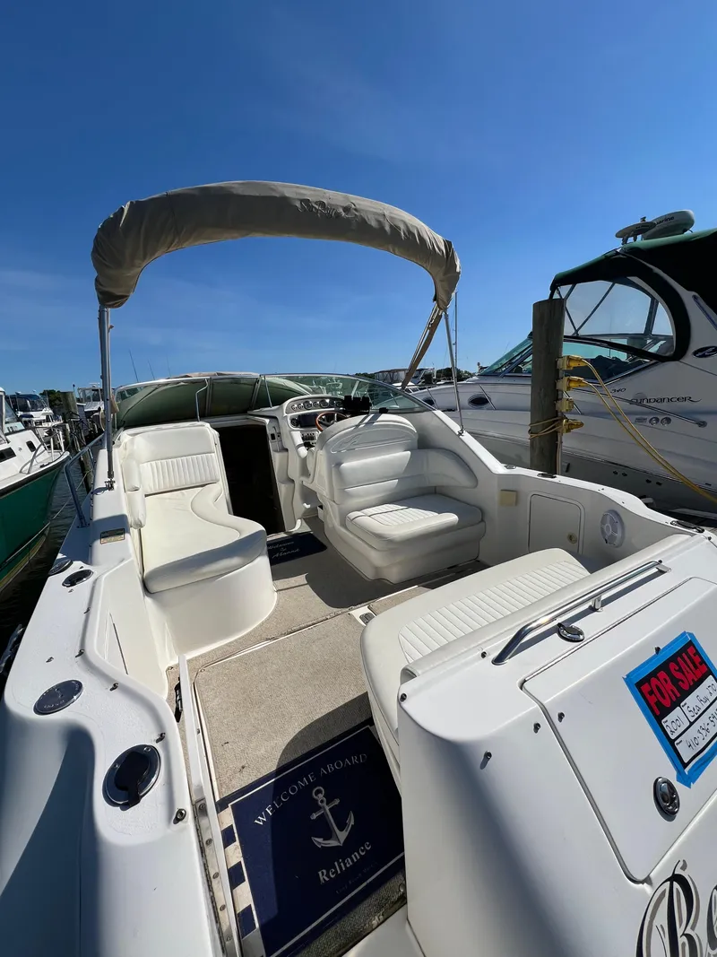 Slide: The Image of 2001 Sea Ray 270 Sundancer boat interior with seating and For Sale sign. - 6