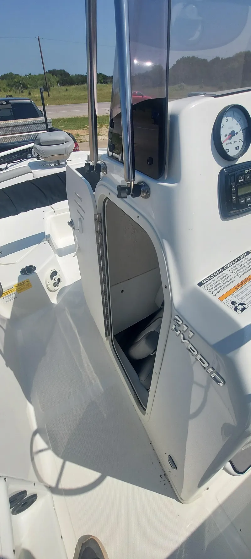 Slide: The Image of 2021 NauticStar 211 Hybrid boat console with storage compartment. - 23