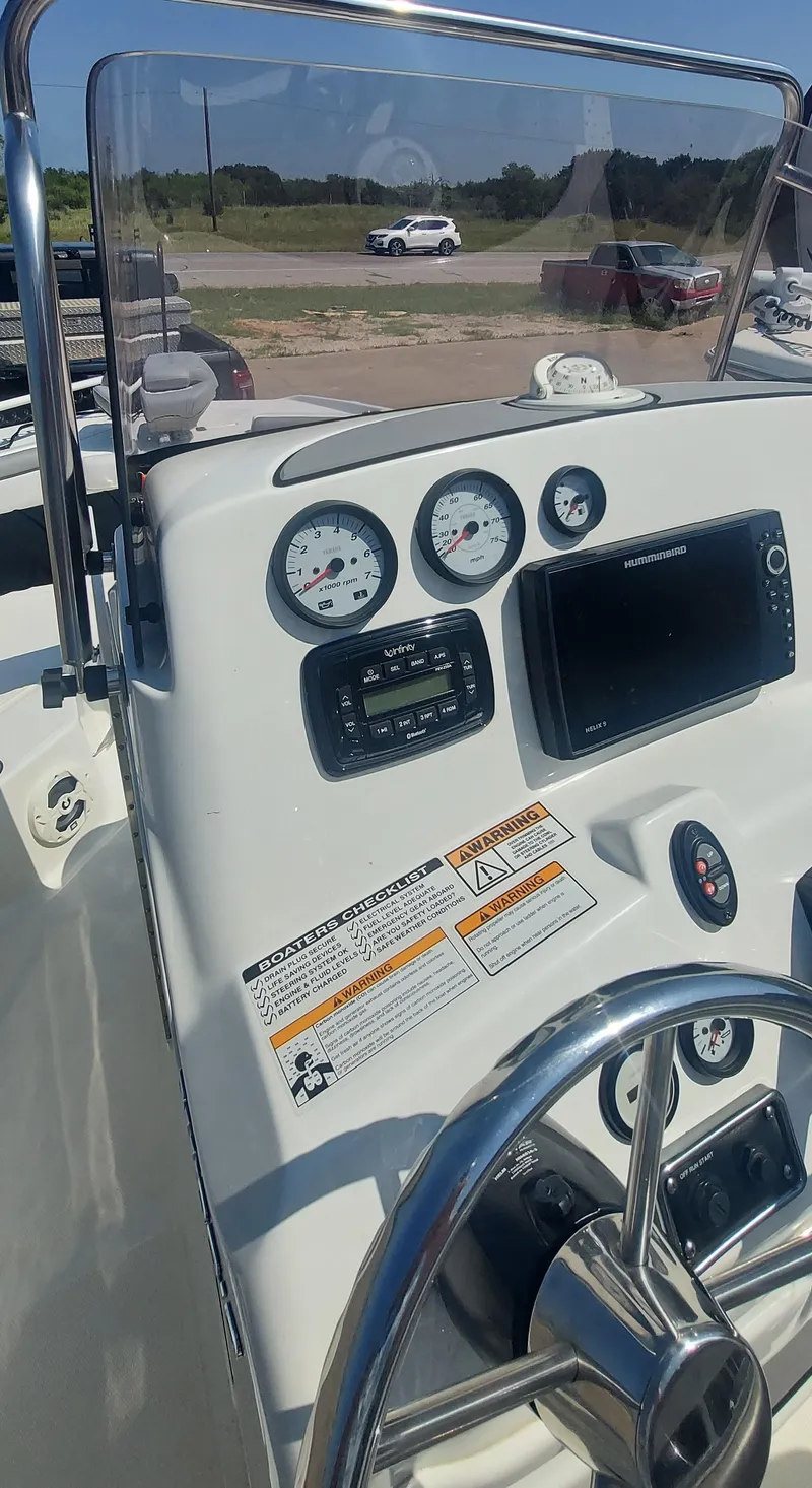 Slide: The Image of 2021 NauticStar 211 Hybrid boat dashboard with gauges and controls. - 24
