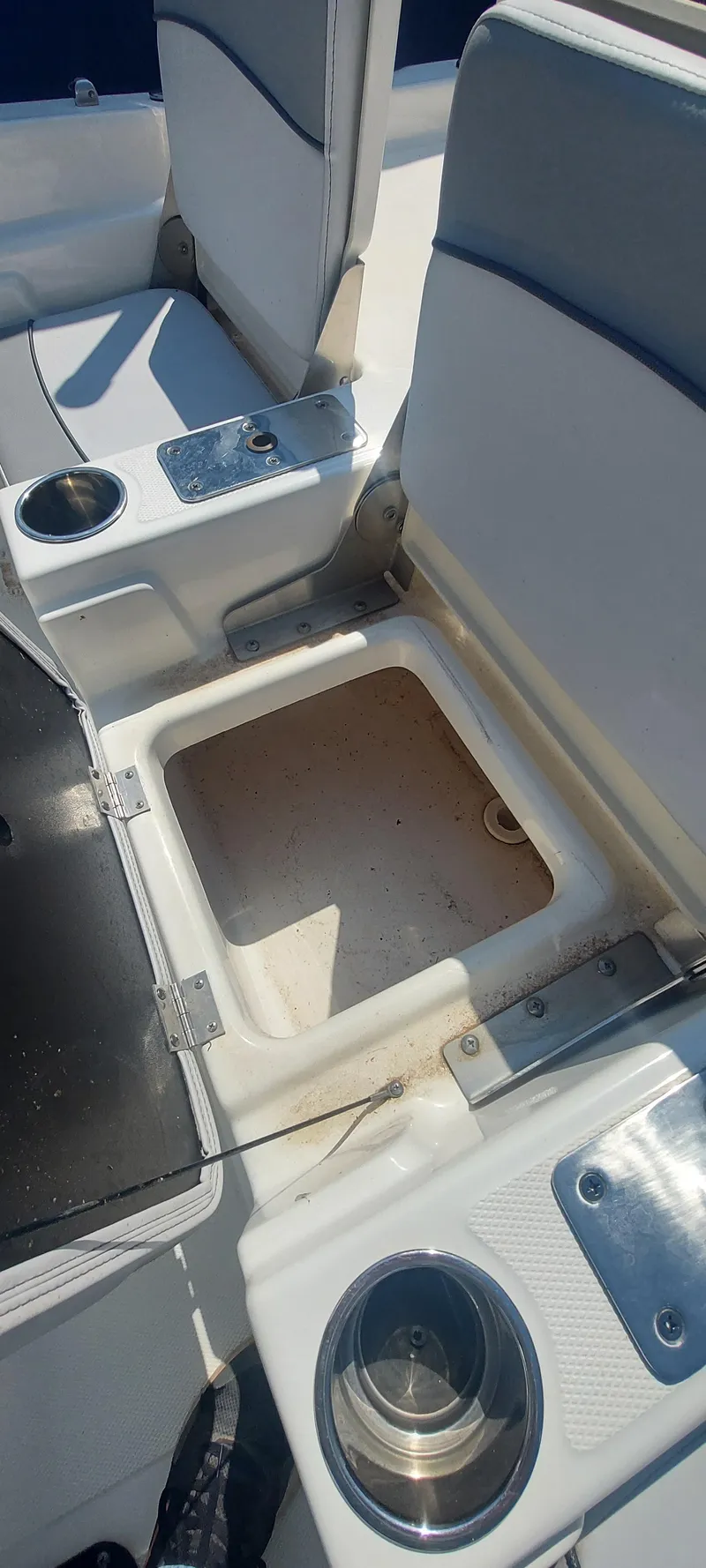 Slide: The Image of 2021 NauticStar 211 Hybrid boat interior with storage compartment and cup holders. - 7
