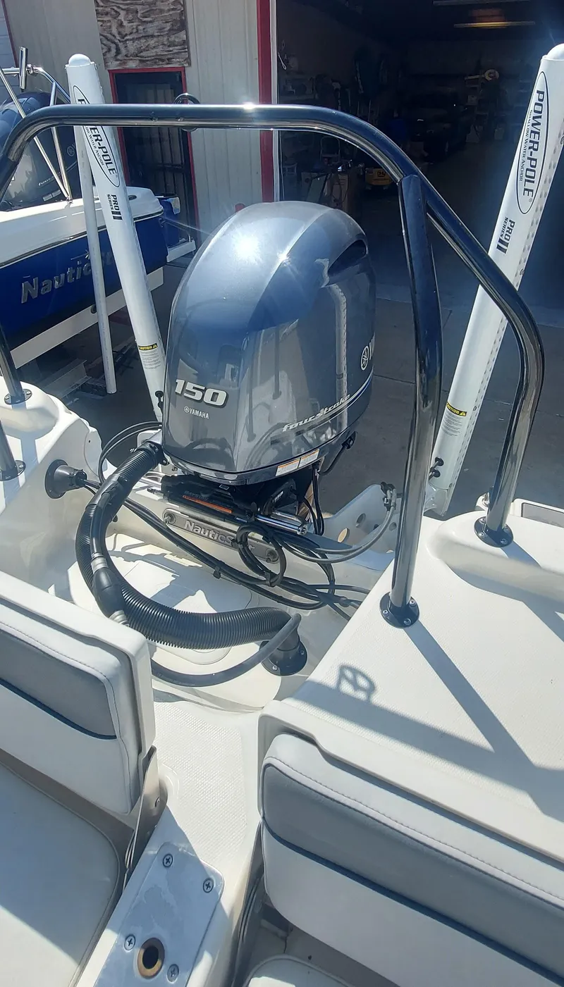 Slide: The Image of 2021 NauticStar 211 Hybrid boat with a 150 HP outboard motor. - 8