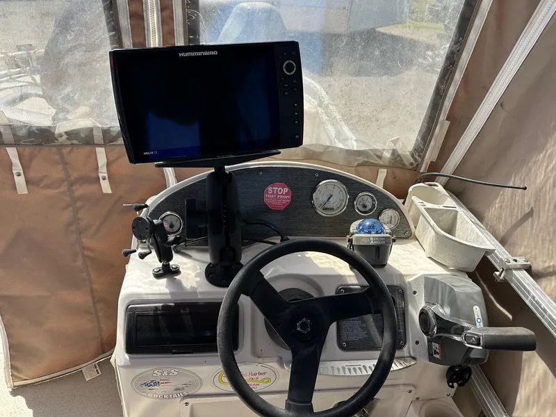 Slide: The Image of Boat dashboard of a 2008 Avalon 2225 Fish with Humminbird Helix 12 fish finder. - 21