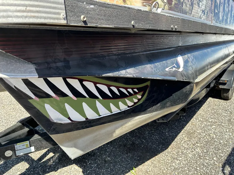 Slide: The Image of Close-up of 2008 Avalon 2225 Fish boat with shark teeth decal on 2020 trailer. - 24