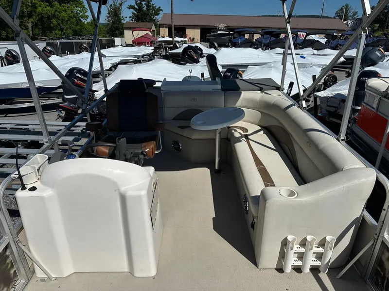 Slide: The Image of 2008 Avalon 2225 Fish pontoon boat interior with seating and fishing rod holders. - 3