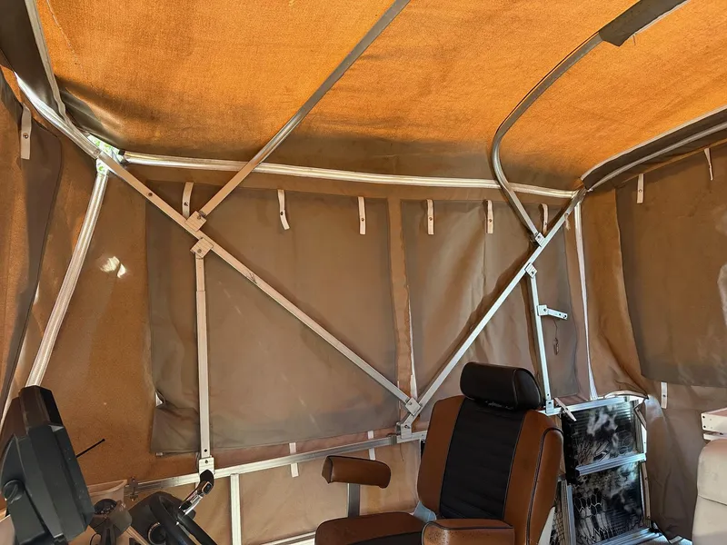 Slide: The Image of Interior of 2008 Avalon 2225 Fish boat with brown canopy and seating. - 6