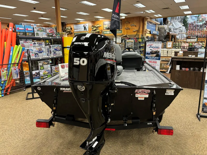 Slide: The Image of 2024 Tracker Bass Tracker Classic XL boat with Mercury 50 engine in showroom. - 2