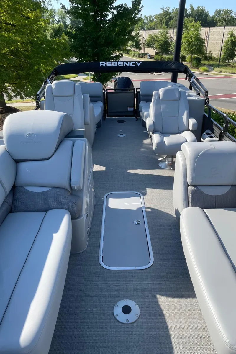 Slide: The Image of 2024 Regency 230 DL3 pontoon boat with luxurious seating and spacious deck. - 2