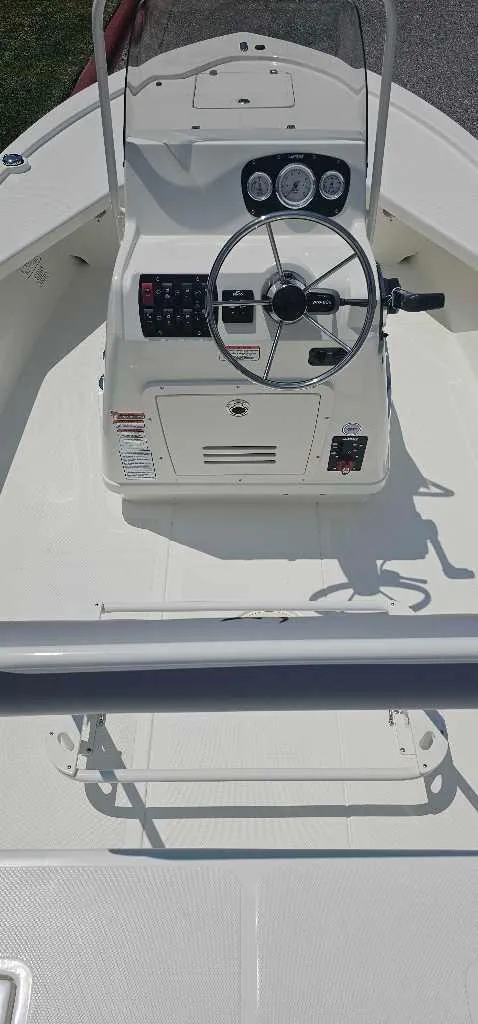 Slide: The Image of 2024 Mako 18 LTS boat console with steering wheel and control panel. - 3