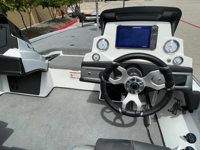 Slide: The Image of 2024 Nitro Z20 Pro boat dashboard with steering wheel and navigation system. - 2