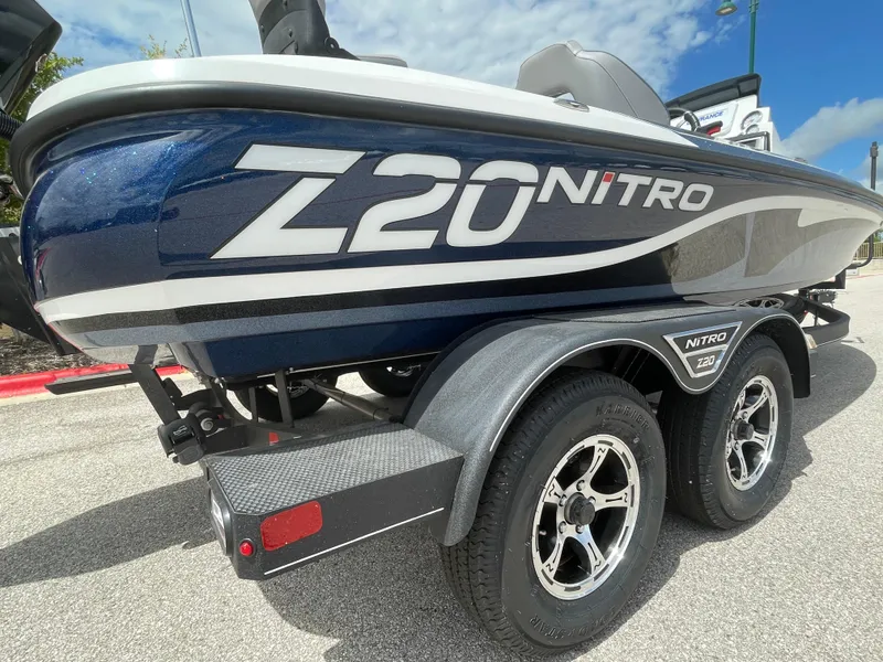 Slide: The Image of 2024 Nitro Z20 Pro boat on trailer, blue and white design, sunny day. - 4
