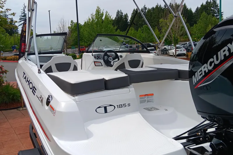 Slide: The Image of 2024 Tahoe 185 S boat with Mercury engine, docked outdoors. - 4