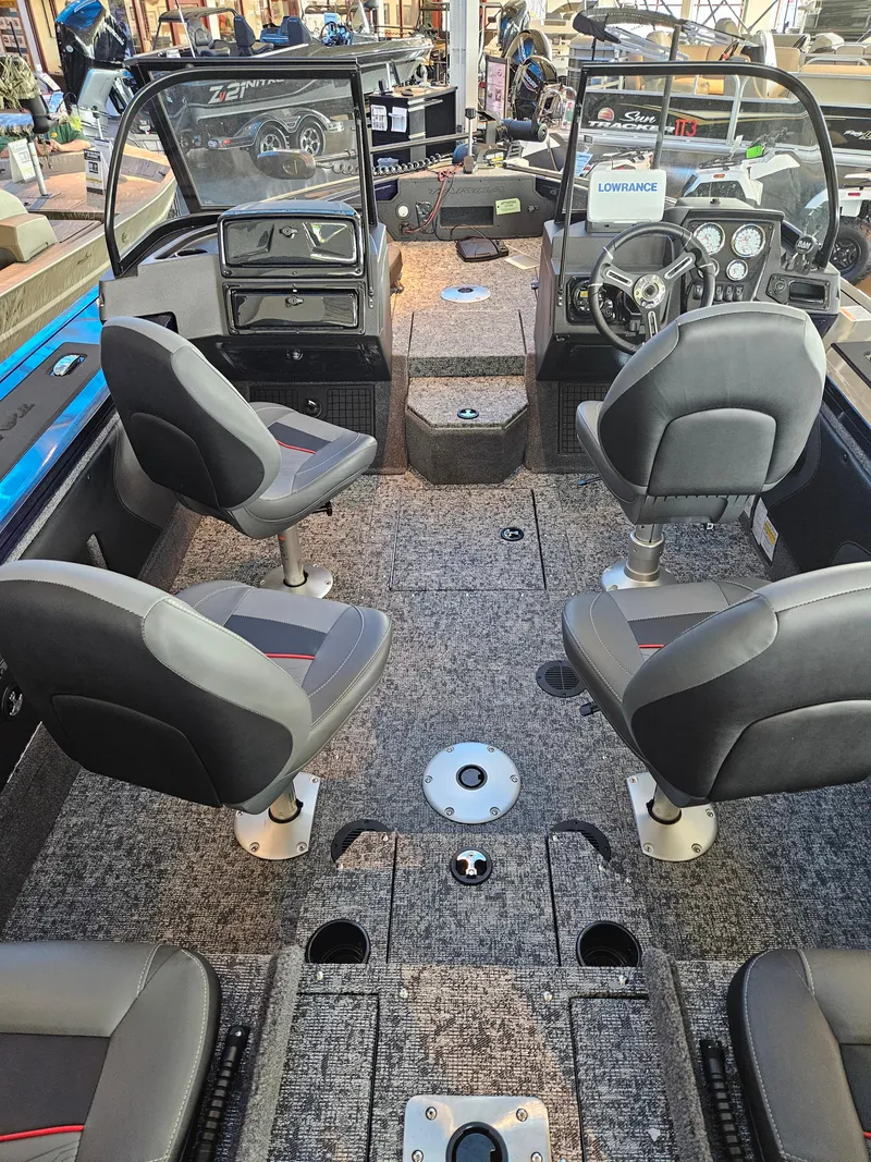 Slide: The Image of 2024 Tracker Targa V-19 Combo boat interior with seating and dashboard. - 2