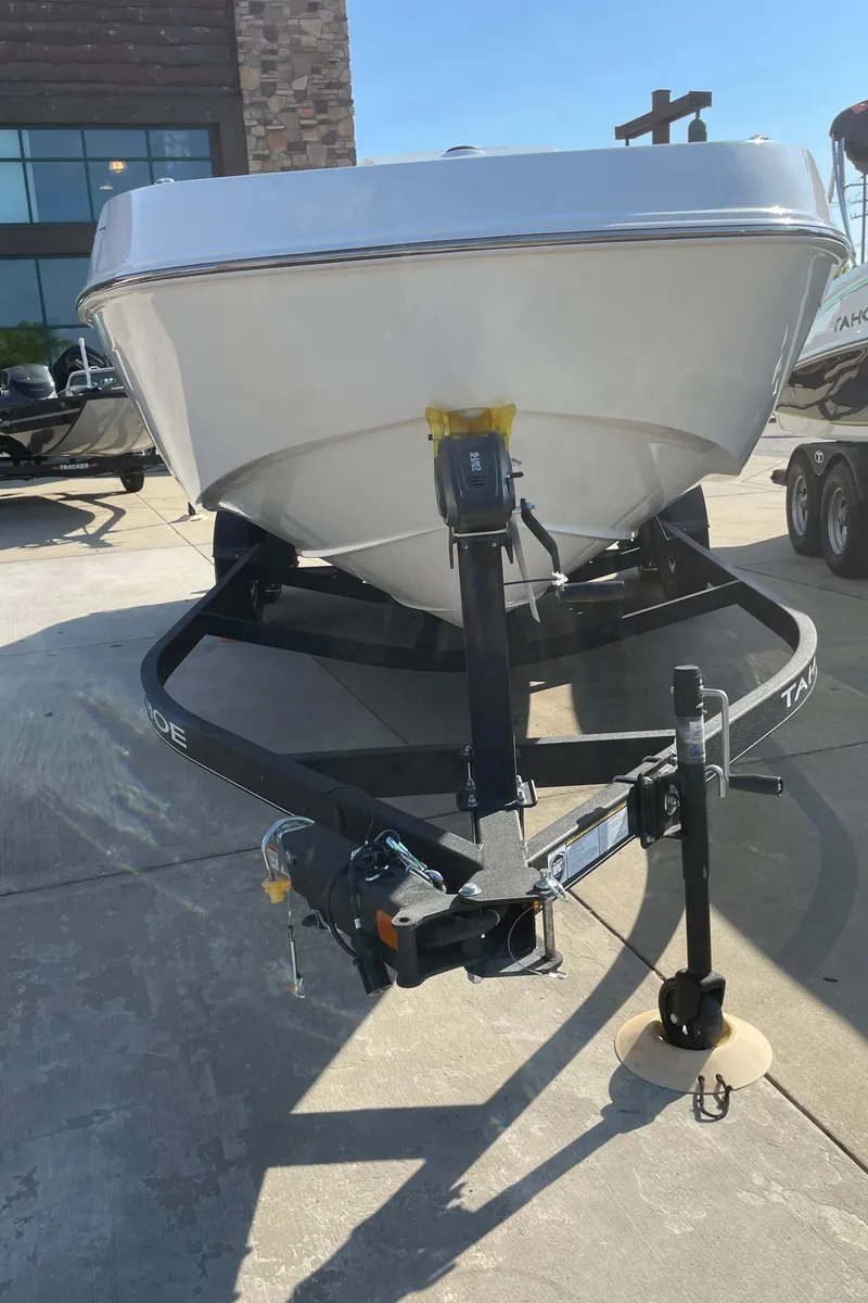 Slide: The Image of 2024 Tahoe T21 boat on a trailer, front view, outdoor display. - 1