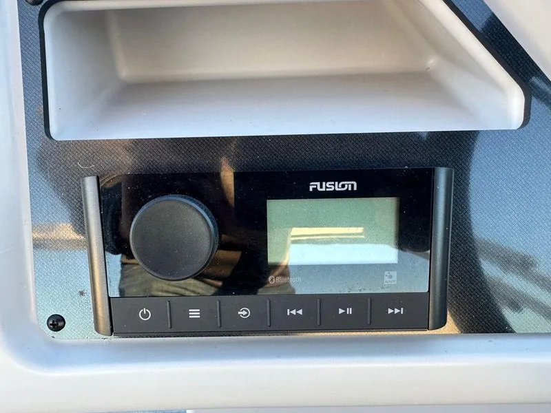 Slide: The Image of 2024 Godfrey Xperience 1886 CX boat stereo system with Fusion audio controls. - 10