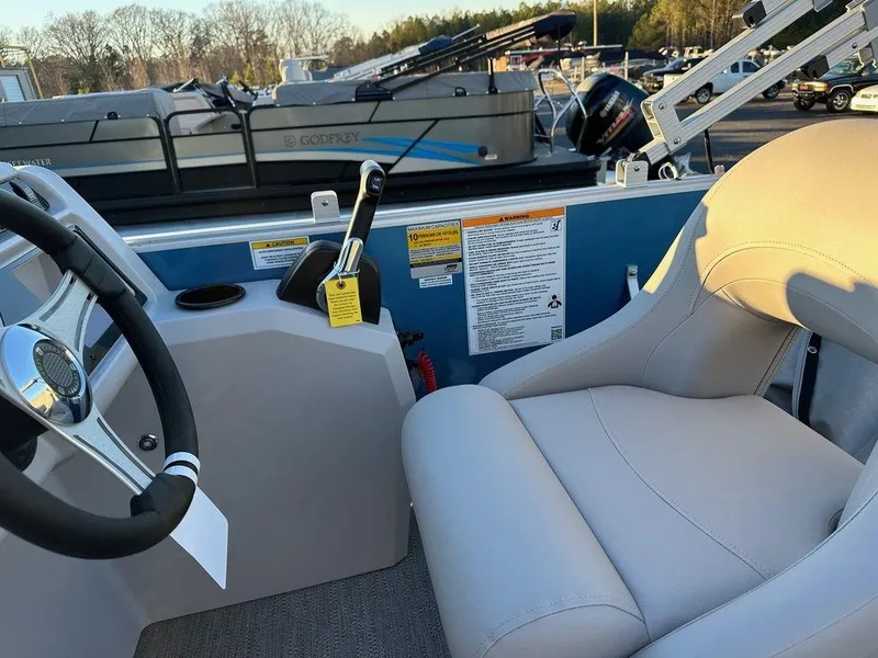 Slide: The Image of 2024 Godfrey Xperience 1886 CX boat interior with steering wheel and control panel. - 11