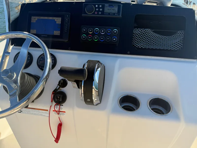Slide: The Image of 2021 Scout 215 XSF boat dashboard with steering wheel and controls. - 11
