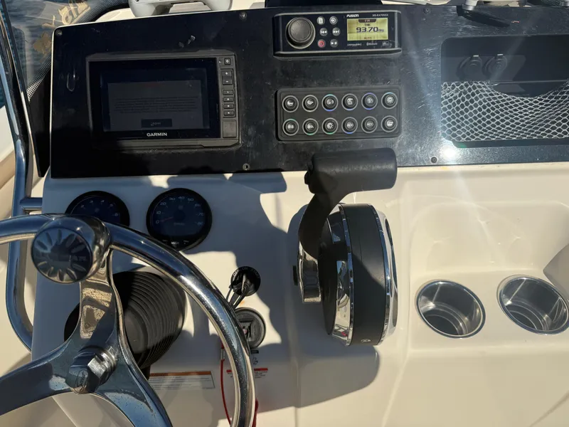 Slide: The Image of 2021 Scout 215 XSF boat dashboard with steering wheel and control panel. - 16