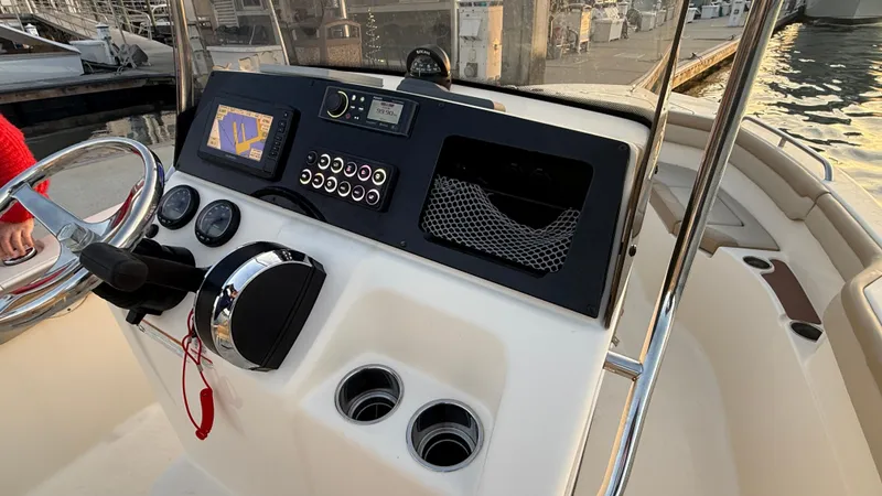 Slide: The Image of 2021 Scout 215 XSF boat dashboard with navigation system and controls. - 23