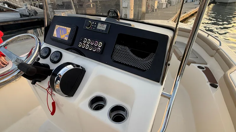 Slide: The Image of 2021 Scout 215 XSF boat dashboard with navigation system and controls. - 24