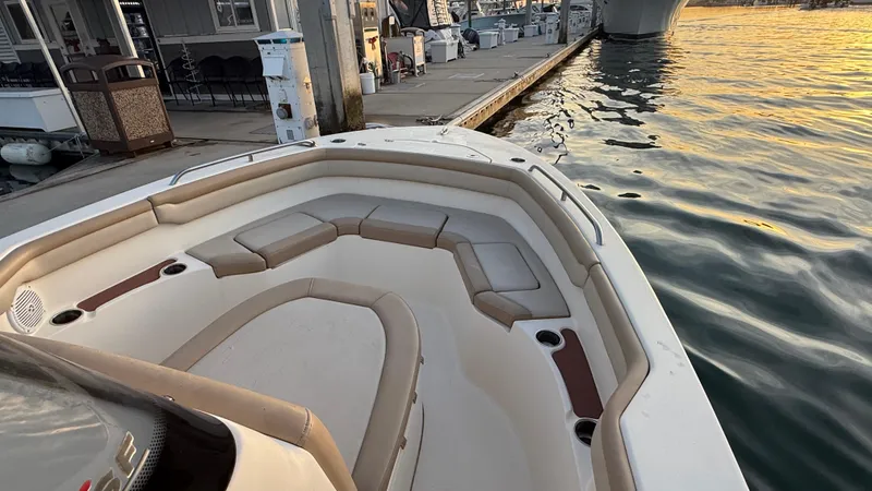 Slide: The Image of 2021 Scout 215 XSF boat docked at sunset, featuring spacious seating. - 28