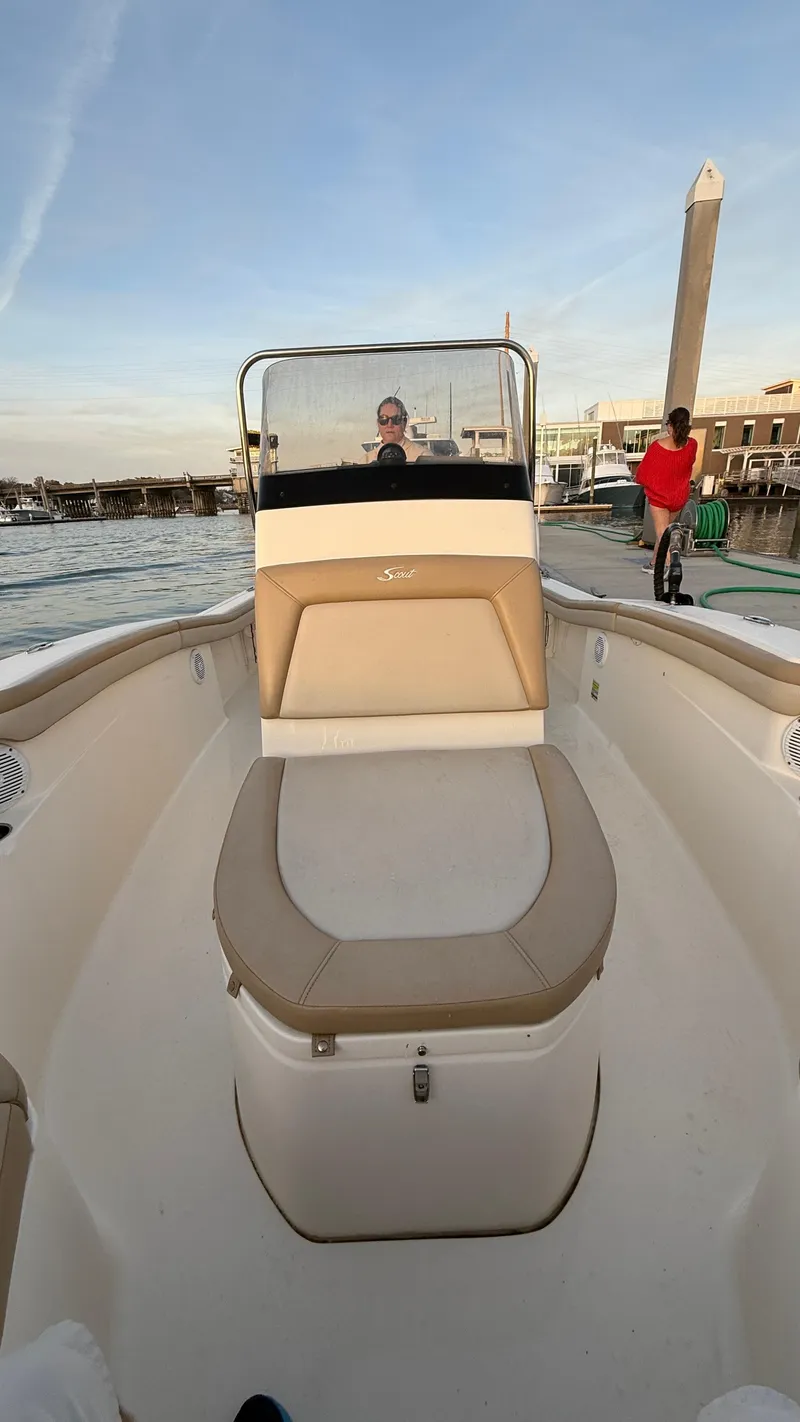 Slide: The Image of 2021 Scout 215 XSF boat at dock, featuring spacious seating and modern design. - 31