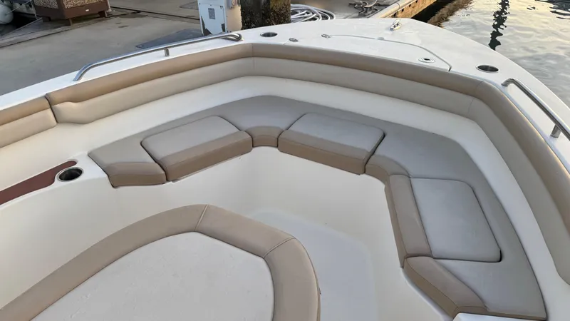 Slide: The Image of 2021 Scout 215 XSF boat interior with cushioned seating area. - 32