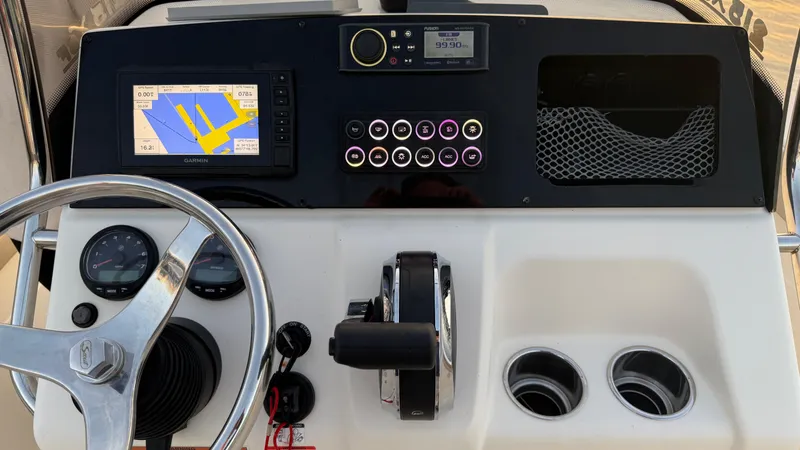 Slide: The Image of 2021 Scout 215 XSF boat dashboard with navigation system and controls. - 33