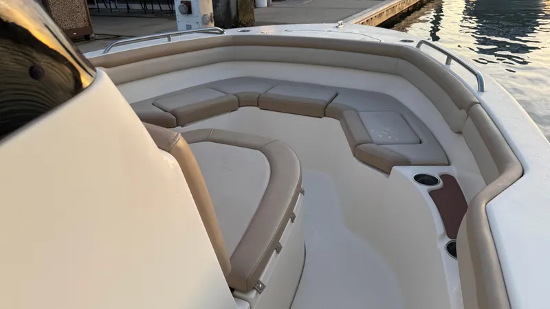 Slide: The Image of 2021 Scout 215 XSF boat interior with cushioned seating and cup holders. - 34