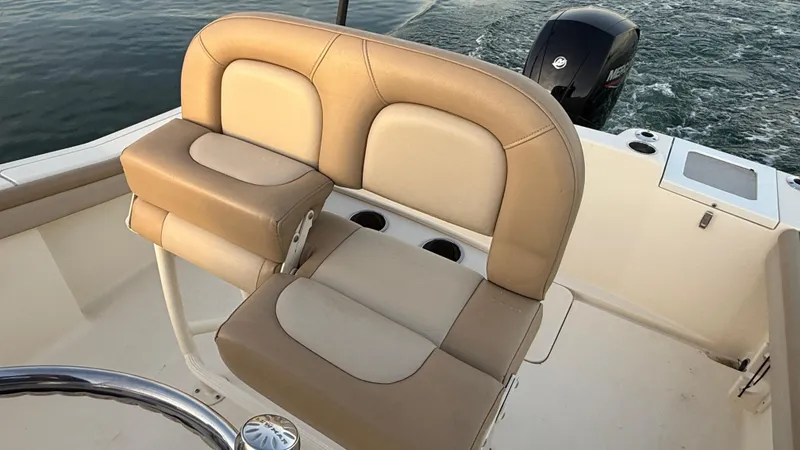 Slide: The Image of 2021 Scout 215 XSF boat with tan seating and outboard motor. - 38