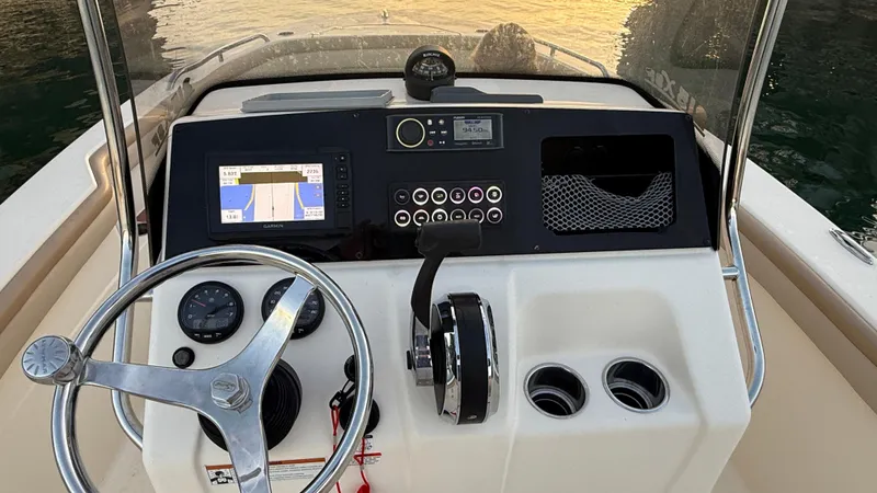 Slide: The Image of 2021 Scout 215 XSF boat dashboard with steering wheel and navigation system. - 39