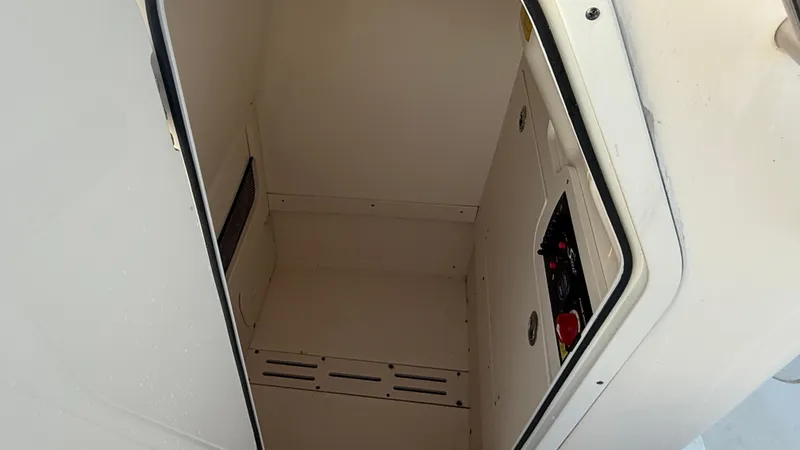 Slide: The Image of 2021 Scout 215 XSF boat storage compartment interior. - 46