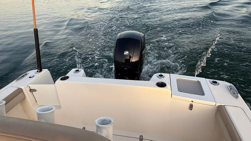Slide: The Image of 2021 Scout 215 XSF boat with outboard motor on water. - 47