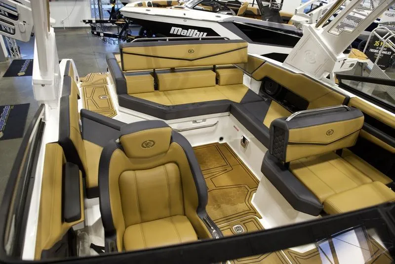 Slide: The Image of 2024 Cobalt R4 Surf boat interior with tan and black seating. - 15