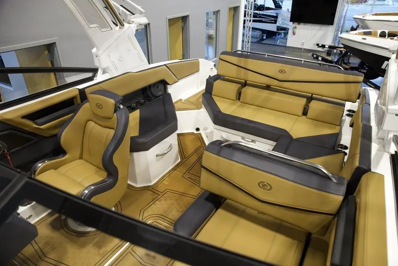 Slide: The Image of 2024 Cobalt R4 Surf boat interior with luxurious tan and black seating. - 17