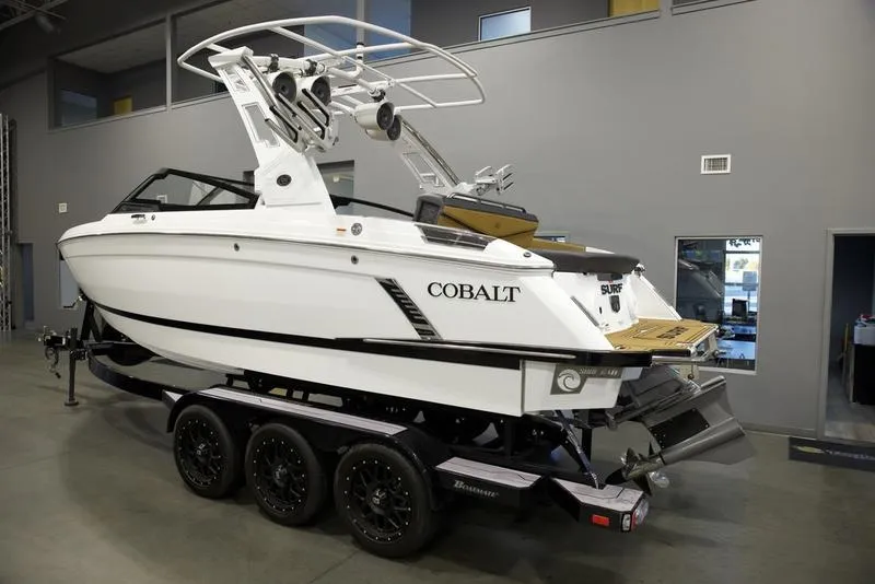 Slide: The Image of 2024 Cobalt R4 Surf boat on trailer in showroom. - 2