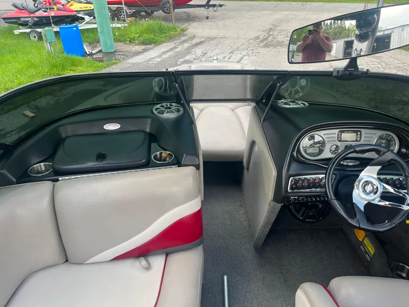 Slide: The Image of 2008 Malibu 21 vRide boat interior with steering wheel and seating. - 11