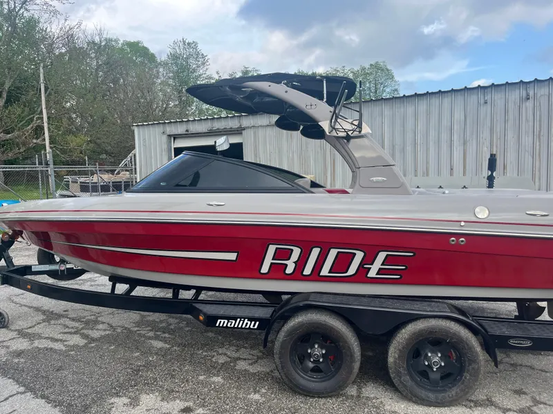 Slide: The Image of 2008 Malibu 21 vRide boat on trailer, red and gray, parked outdoors. - 9