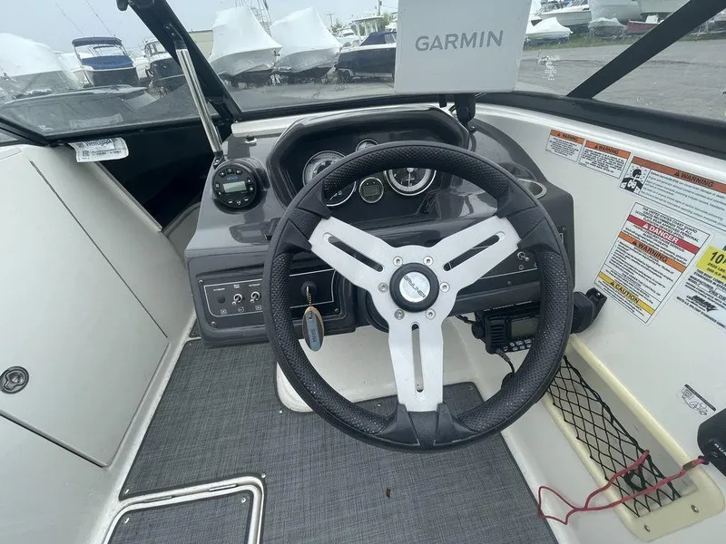 Slide: The Image of 2021 Bayliner VR6 OB boat cockpit with Garmin navigation system and steering wheel. - 10